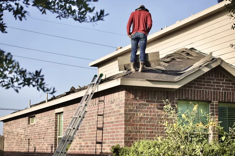 Professional roofer working on a residential roof in North Madison